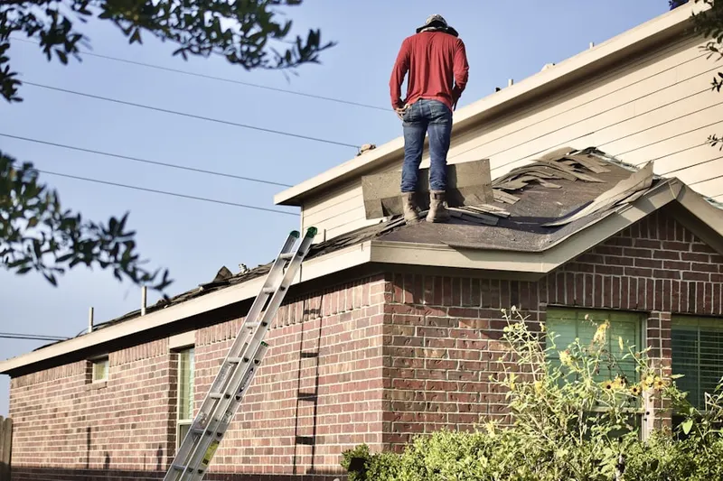 Professional roofer working on a residential roof in Upper Darby